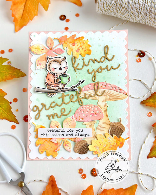 Autumn-themed card with owl and mushrooms, surrounded by fall leaves and decorative items.