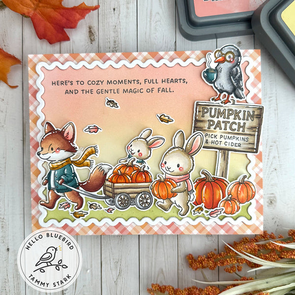 Autumn-themed card with fox, rabbit, and bird illustration on a wooden surface.